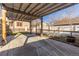 Backyard pergola features a covered concrete patio, a fence, and planter beds at 1556 Osceola St, Denver, CO 80204