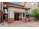 Buildings C & D entrance with brick and stucco, along with decorative lighting, iron gates, and a small tree nearby at 5401 S Park Terrace Ave # 204C, Greenwood Village, CO 80111