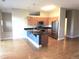 Open kitchen featuring stainless steel appliances, a kitchen island with sink, and hardwood floors at 5401 S Park Terrace Ave # 204C, Greenwood Village, CO 80111