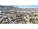 Scenic aerial view of a neighborhood surrounded by majestic mountains and unique rock formations, blending nature and community at 10576 Roxborough Dr, Littleton, CO 80125