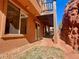 Backyard patio beneath a wooden deck with exterior access from the basement at 10576 Roxborough Dr, Littleton, CO 80125