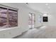 A finished basement with a carpeted floor, light walls, and sliding glass doors to the exterior at 10576 Roxborough Dr, Littleton, CO 80125