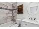 Modern bathroom featuring a marble tiled shower and a wooden shelf and oval mirror at 10576 Roxborough Dr, Littleton, CO 80125