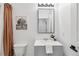 Well-lit half bathroom with a modern vanity, sleek mirror, and fresh decor at 10576 Roxborough Dr, Littleton, CO 80125