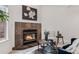 Cozy living room featuring a stone fireplace and large windows providing natural light at 10576 Roxborough Dr, Littleton, CO 80125