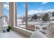 Breathtaking view of the snowy mountains through a large window at 10576 Roxborough Dr, Littleton, CO 80125