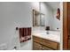 Powder room featuring wood vanity with tile countertop and single sink at 120 Windwood Cir, Breckenridge, CO 80424