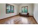 Bright bedroom with hardwood floors, dual windows, and a comfortable chaise lounge at 120 Windwood Cir, Breckenridge, CO 80424