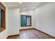 Empty bedroom with hardwood floors, neutral walls, and windows offering views of the outdoors at 120 Windwood Cir, Breckenridge, CO 80424