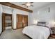 Bedroom features a beamed ceiling, carpet, closet with louvered doors, and ensuite at 120 Windwood Cir, Breckenridge, CO 80424