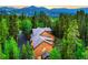 Stunning mountain home nestled among mature trees, offering privacy and scenic views at 120 Windwood Cir, Breckenridge, CO 80424