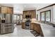 Well-equipped kitchen with wood cabinets, stainless steel appliances, and adjacent dining area with wooded views at 120 Windwood Cir, Breckenridge, CO 80424