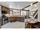Open kitchen with wood cabinets, an island with bar seating, stainless steel appliances, and a view to living area at 120 Windwood Cir, Breckenridge, CO 80424