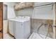 Practical laundry room with a washer, dryer, wash sink, and ample storage cabinets at 120 Windwood Cir, Breckenridge, CO 80424