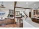 Open-concept design showcasing the living room with a stone fireplace adjacent to the kitchen and staircase at 120 Windwood Cir, Breckenridge, CO 80424