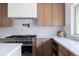 Modern kitchen featuring stainless steel appliances, light wood cabinets, and quartz countertops at 8309 W 69Th Way, Arvada, CO 80004