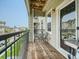 Private balcony with wooden decking, bistro set, and string lights at 11250 Florence St # 28E, Commerce City, CO 80640