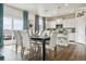 Modern kitchen with white cabinets, granite countertops, and an island at 7548 E 159Th Pl, Thornton, CO 80602