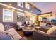 An outdoor patio with sofas, chairs, fire pit, and a TV on the back of the house at 1825 Wingfeather Ln, Castle Rock, CO 80108
