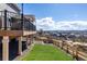 A spacious backyard with a covered deck and a view of the surrounding neighborhood at 1825 Wingfeather Ln, Castle Rock, CO 80108