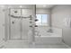Bright bathroom featuring a soaking tub, shower, and a window with scenic views at 1825 Wingfeather Ln, Castle Rock, CO 80108