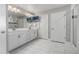 Bright and spacious bathroom features dual sinks, tile flooring, and glass-enclosed shower at 1825 Wingfeather Ln, Castle Rock, CO 80108
