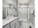 Bright bathroom featuring a white vanity, glass-enclosed shower, and modern finishes at 1825 Wingfeather Ln, Castle Rock, CO 80108