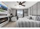 Bedroom featuring a large bed, ceiling fan, fireplace, and window with neighborhood view at 1825 Wingfeather Ln, Castle Rock, CO 80108
