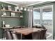 Cozy dining area featuring wooden shelves, seating for eight, and views of the neighborhood at 1825 Wingfeather Ln, Castle Rock, CO 80108
