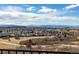 A distant view of the city with new home construction with a nice mountain backdrop at 1825 Wingfeather Ln, Castle Rock, CO 80108