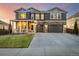 Inviting two-story home with a covered front porch, stone accents, and an attached two-car garage at 1825 Wingfeather Ln, Castle Rock, CO 80108