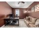 Comfortable home office with a large desk, plush sofa, and stylish floor lamp at 1825 Wingfeather Ln, Castle Rock, CO 80108