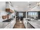 Modern kitchen showcasing granite countertops, white cabinets, and hardwood floors at 1825 Wingfeather Ln, Castle Rock, CO 80108