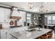 Modern kitchen with a granite island, white cabinets, and stainless steel appliances at 1825 Wingfeather Ln, Castle Rock, CO 80108
