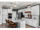 Bright kitchen featuring a large island, white cabinets, and modern appliances at 1825 Wingfeather Ln, Castle Rock, CO 80108