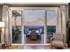 Open living room with large sliding doors offering scenic views of the city and mountains at 1825 Wingfeather Ln, Castle Rock, CO 80108