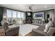Comfortable living room with a fireplace, large windows, and a sliding glass door at 1825 Wingfeather Ln, Castle Rock, CO 80108