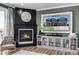 Cozy living room boasts a fireplace, custom built-ins, and a mounted television at 1825 Wingfeather Ln, Castle Rock, CO 80108