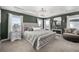Luxurious main bedroom suite featuring a tray ceiling, chandelier, and sitting area at 1825 Wingfeather Ln, Castle Rock, CO 80108