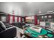 A movie theater room with reclining seats, a screen, a beverage center, and a game table at 1825 Wingfeather Ln, Castle Rock, CO 80108