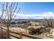 Scenic view of the neighborhood from a vantage point with rock outcroppings and a fence at 1825 Wingfeather Ln, Castle Rock, CO 80108