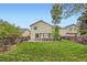 Expansive backyard features a well-maintained lawn, patio, and mature trees at 4349 S Genoa Ct, Centennial, CO 80015