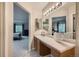 Bathroom with a single sink vanity, vanity lighting, and a view into the spacious primary bedroom at 4349 S Genoa Ct, Centennial, CO 80015