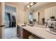 Bright bathroom with a single sink vanity, vanity lighting, and access into the bedroom at 4349 S Genoa Ct, Centennial, CO 80015