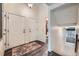 Inviting entryway featuring hardwood floors, neutral walls, high ceilings, and a view into the downstairs bathroom at 4349 S Genoa Ct, Centennial, CO 80015