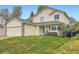 Lovely two-story home with yellow siding, attached garage, a well-kept lawn, and a bright blue front door at 4349 S Genoa Ct, Centennial, CO 80015