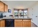 Bright kitchen with granite countertops, wood cabinets, and a large bay window seating area at 4349 S Genoa Ct, Centennial, CO 80015