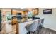 Open kitchen with granite countertops, wood cabinets, a breakfast bar, and stainless steel appliances at 4349 S Genoa Ct, Centennial, CO 80015