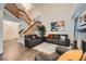 Spacious living room with a wooden staircase, fireplace, comfortable seating, neutral walls, and hardwood floors at 4349 S Genoa Ct, Centennial, CO 80015