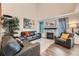 Bright living room with a high ceiling, hardwood floors, neutral walls, a fireplace, and comfortable furniture at 4349 S Genoa Ct, Centennial, CO 80015
